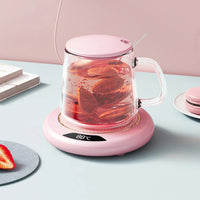 Chauffe Tasse Électrique Rose Compact et Portable, sur une table.